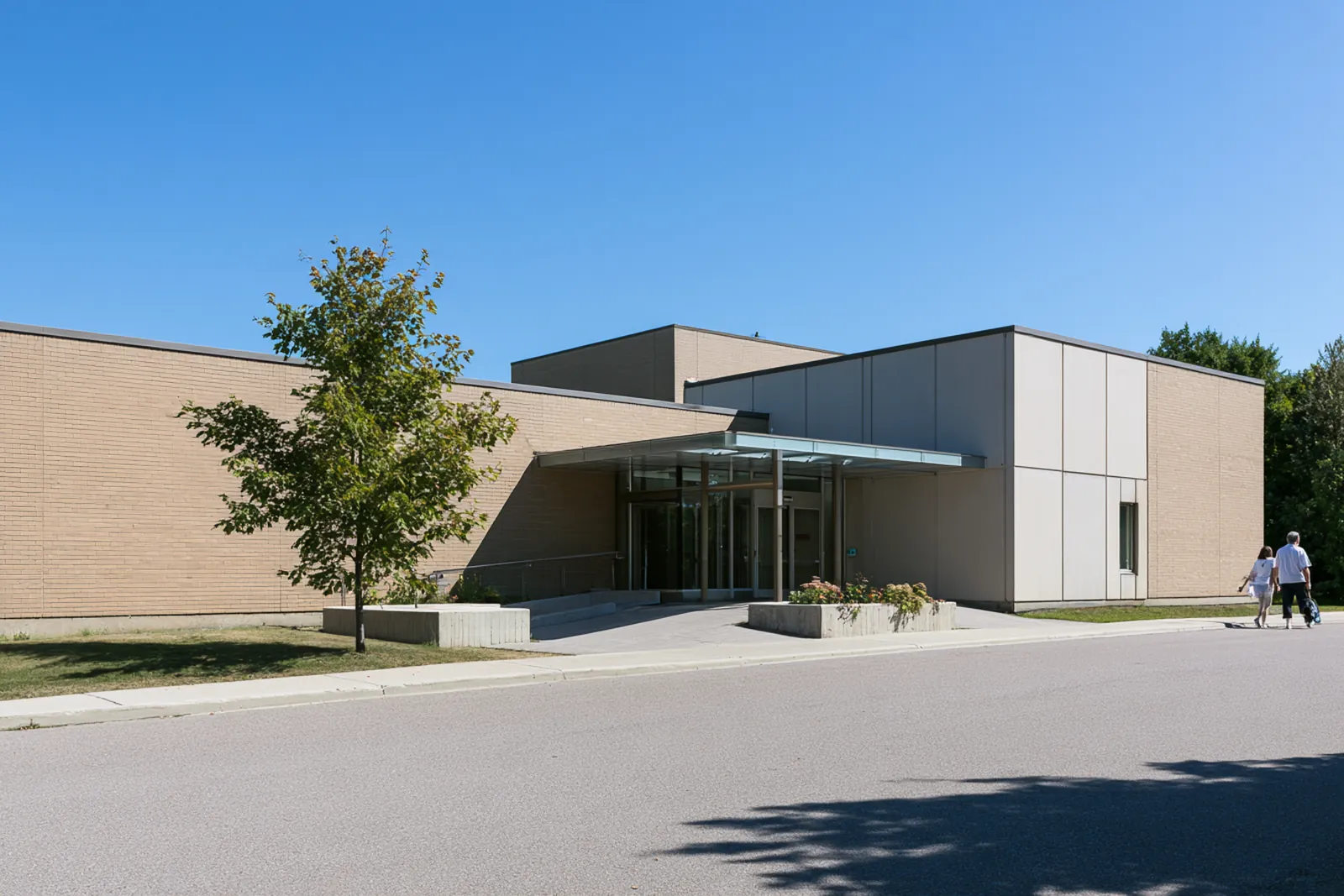 The main entrance of a community hospital on a bright autumn morning